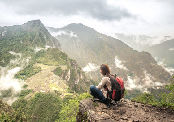 Girl-hiker looking on top of Huayna Picchu, looking on Machu Picchu