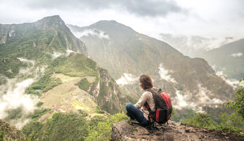 Girl-hiker looking on top of Huayna Picchu, looking on Machu Picchu