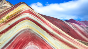 Colorful Rainbow Mountain in Peru, showcasing vibrant layers of red, orange, yellow, green, and blue hues in the Andes